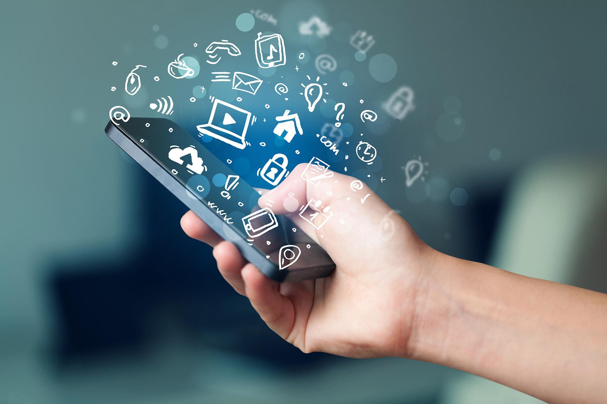 Hand holding smartphone with media icons and symbol